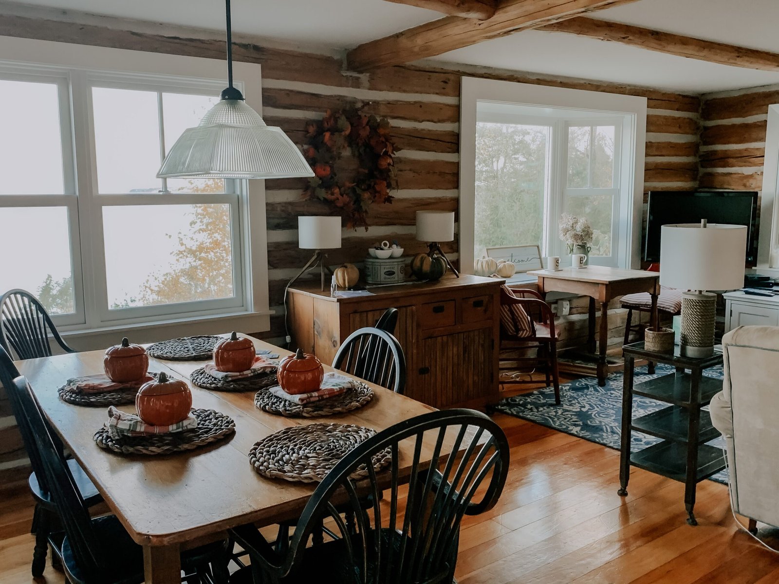 Cute fall dining room with hardwood flooring.